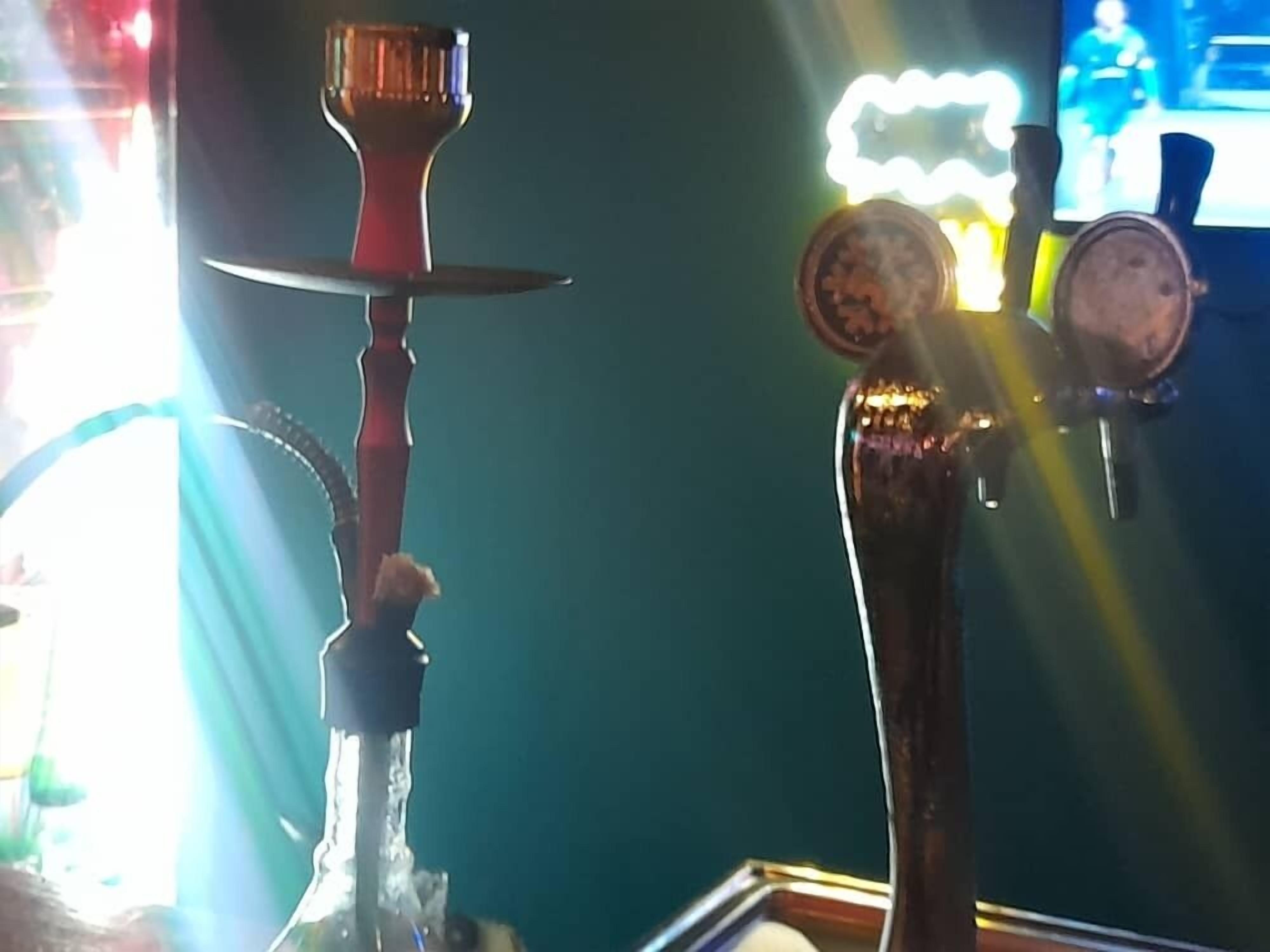 A hookah and a beer tap in a bar setting.