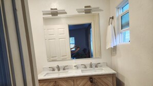 A bathroom with a double sink vanity, a mirror above the sink, and a towel hanging on the wall. - LUXURY 2-bedroom house in brilliant Bisbee with BREATHE taking views (Bisbee)