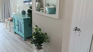 A room with a teal cabinet, a white door, and a large mirror with star decorations. - Charming BEACHFRONT condo in Galveston, 2 POOLS open year round, FITNESS CENTER (Galveston)