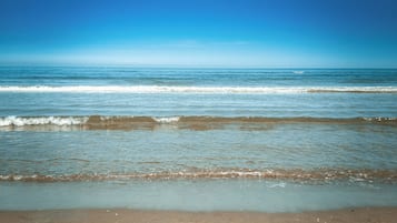 On the beach, sun loungers, beach towels