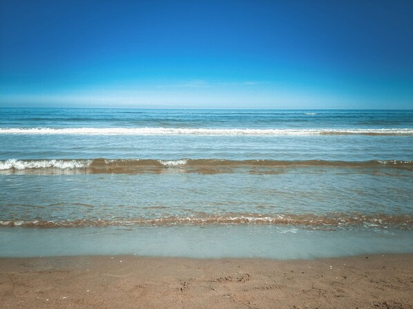 On the beach, sun loungers, beach towels - Charming BEACHFRONT condo in Galveston, 2 POOLS open year round, FITNESS CENTER (Galveston)