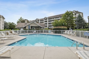 A swimming pool with lounge chairs and a no diving sign. - 1 BR | Whispering Pines | Indoor Pool | Mountain and D'town View (Pigeon Forge)