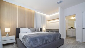 A modern bedroom with a large bed, bedside tables, and a built-in wardrobe. - Last Minute Disney! Private Pool, Hot Tub & Themed Bedrooms. Book Now! #119687 (Orlando)