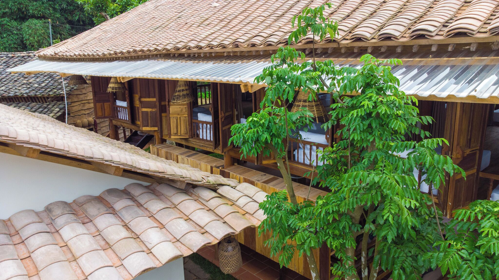 A traditional wooden house with a tiled roof and a balcony.