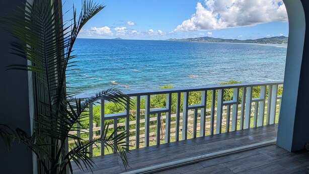 A balcony with a view of the ocean and a distant island. - "Spectacular Ocean Views" at Calypso Castillo! (Sion Farm)