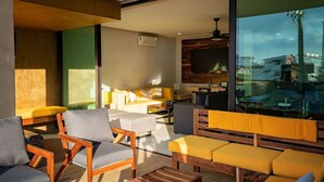 A modern living room with wooden furniture, a sofa set, and a television. - Sunny Puerto Vallarta Condo (Puerto Vallarta)