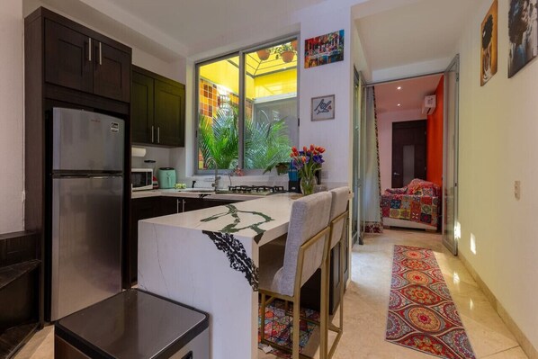 Fridge, microwave, stovetop, coffee/tea maker