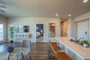 A modern apartment with a kitchen, dining area, and living space.