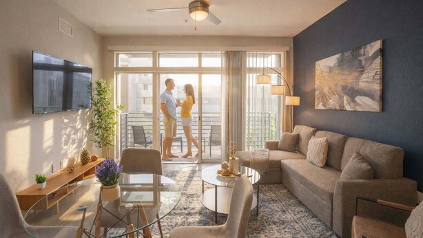A modern living room with a sofa, coffee table, and TV. There is a balcony with a couple standing. - Downtown Phoenix Retreat | Walk to Arts District (Phoenix)