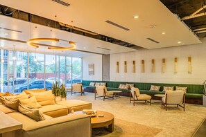 A modern lounge area with sofas, chairs, and a coffee table.