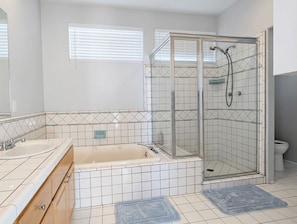 A bathroom with a glass-enclosed shower, a bathtub, and a toilet. - Malibu retreat, Panoramic views, Hot tub, Golf (Malibu)