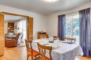 Enjoy meals with family and friends at this dining area, featuring a round table and comfortable seating for four.