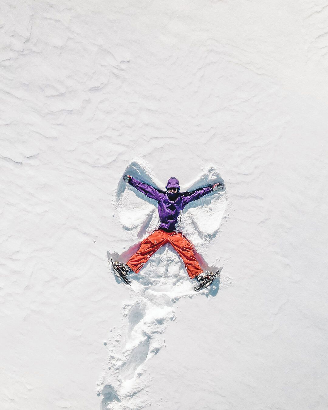 A person snowboarding on a snowy surface.
