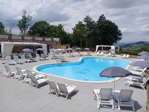 Seasonal outdoor pool, pool umbrellas, pool loungers