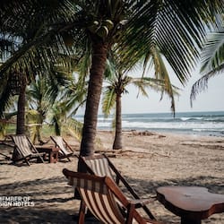 On the beach, white sand, sun-loungers, beach umbrellas