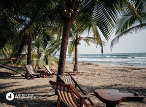 On the beach, white sand, sun-loungers, beach umbrellas