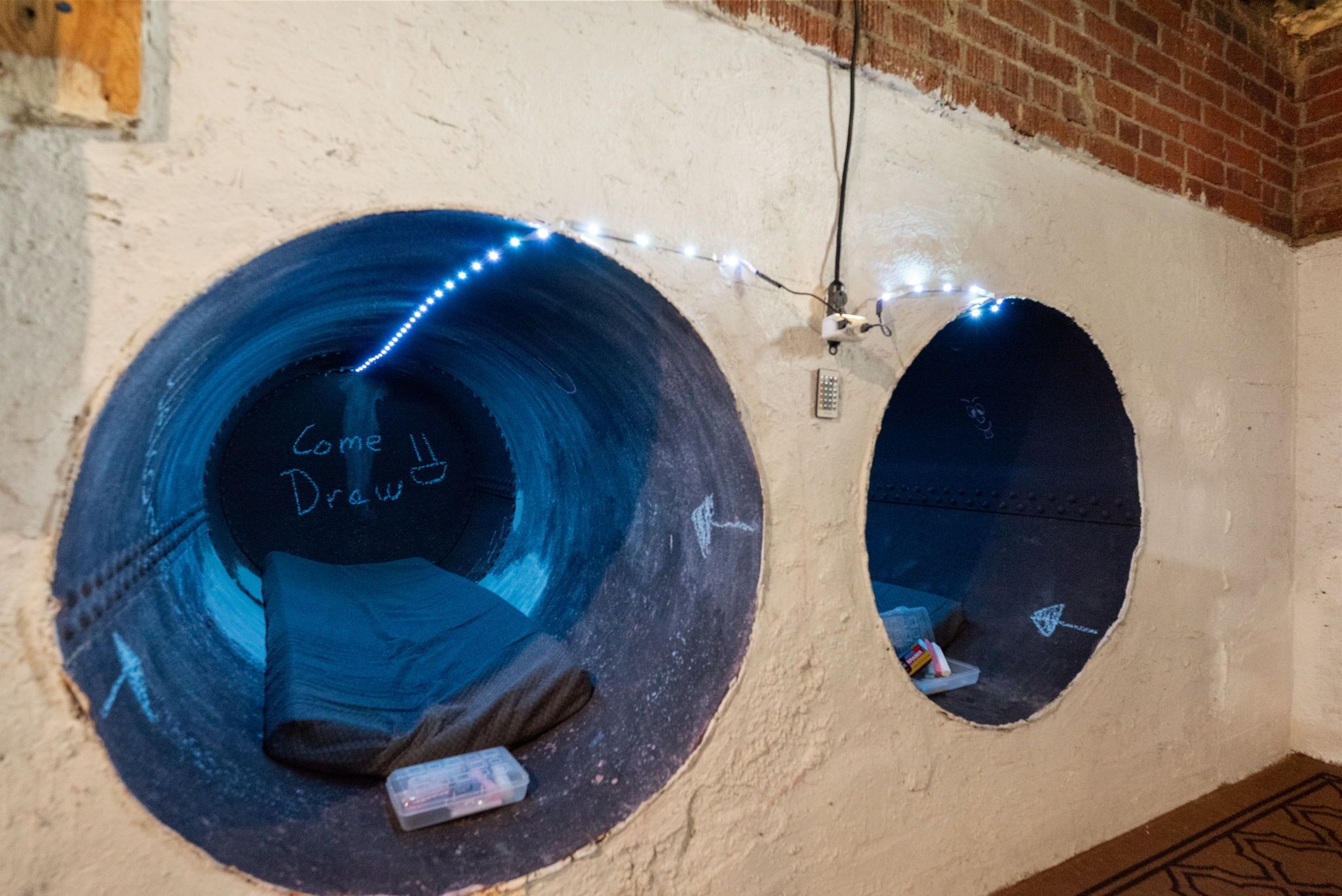 Two circular windows with a blue interior and a small mirror inside.