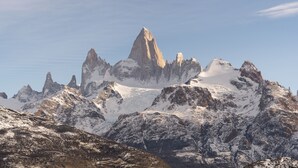 A mountainous landscape with snow-covered peaks and rocky terrain. - OVO Patagonia (El Chalten)