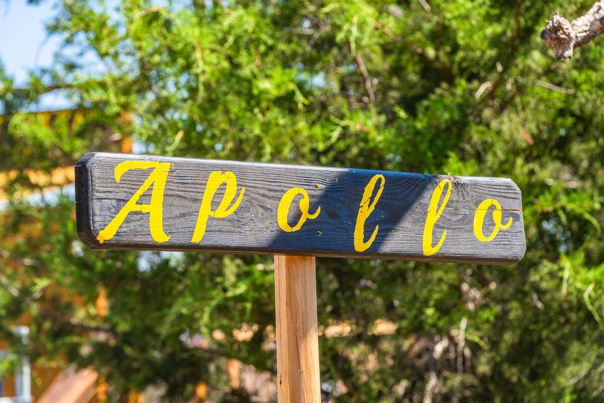 A wooden sign with the word "Apollo" in yellow letters.