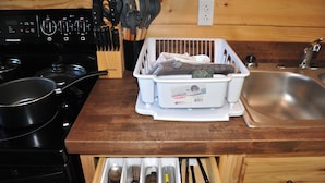 A kitchen with a stove, sink, and drawer with utensils. - Newly Refurbished 2 Bedroom Duplex cabin in Albany, KY with Slip, Wi-Fi #19 (Albany)
