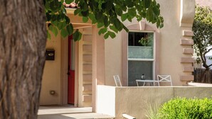 A building with a beige exterior, a red door, and a window. - Best Denver Neighborhood! Walkable to EVERYTHING!  (Denver)