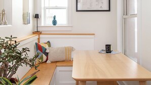 A room with a wooden bench, a table, a potted plant, and a framed document on the wall. - Best Denver Neighborhood! Walkable to EVERYTHING!  (Denver)