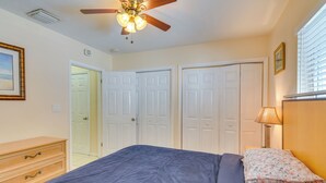 A bedroom with a bed, a dresser, a ceiling fan, and a window with blinds. - Your Ideal 30-Day Furnished Retreat in Hallandale! (Hallandale Beach)