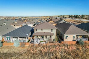 Houses with pitched roofs and varied architectural styles line the landscape.