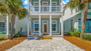 A two-story building with a front porch, a balcony, and a door marked with the number 22704. - 22704 Front Beach Road Ocean Breeze (Panama City Beach)
