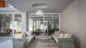 A modern living room with a sofa set, a coffee table, and a hanging light fixture. - Vizion Carilo by D&G (Carilo)