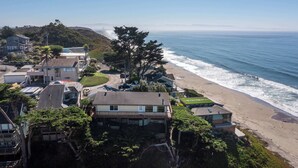A coastal residential area with houses, a beach, and ocean views.