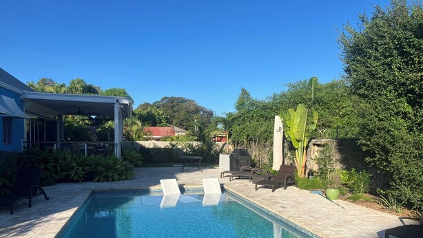A swimming pool with lounge chairs, a covered patio area, and surrounding greenery. - Villa By The Bay
Luxury 3 bedroom all ensuite, private pool, pickleball court (Bridgetown)