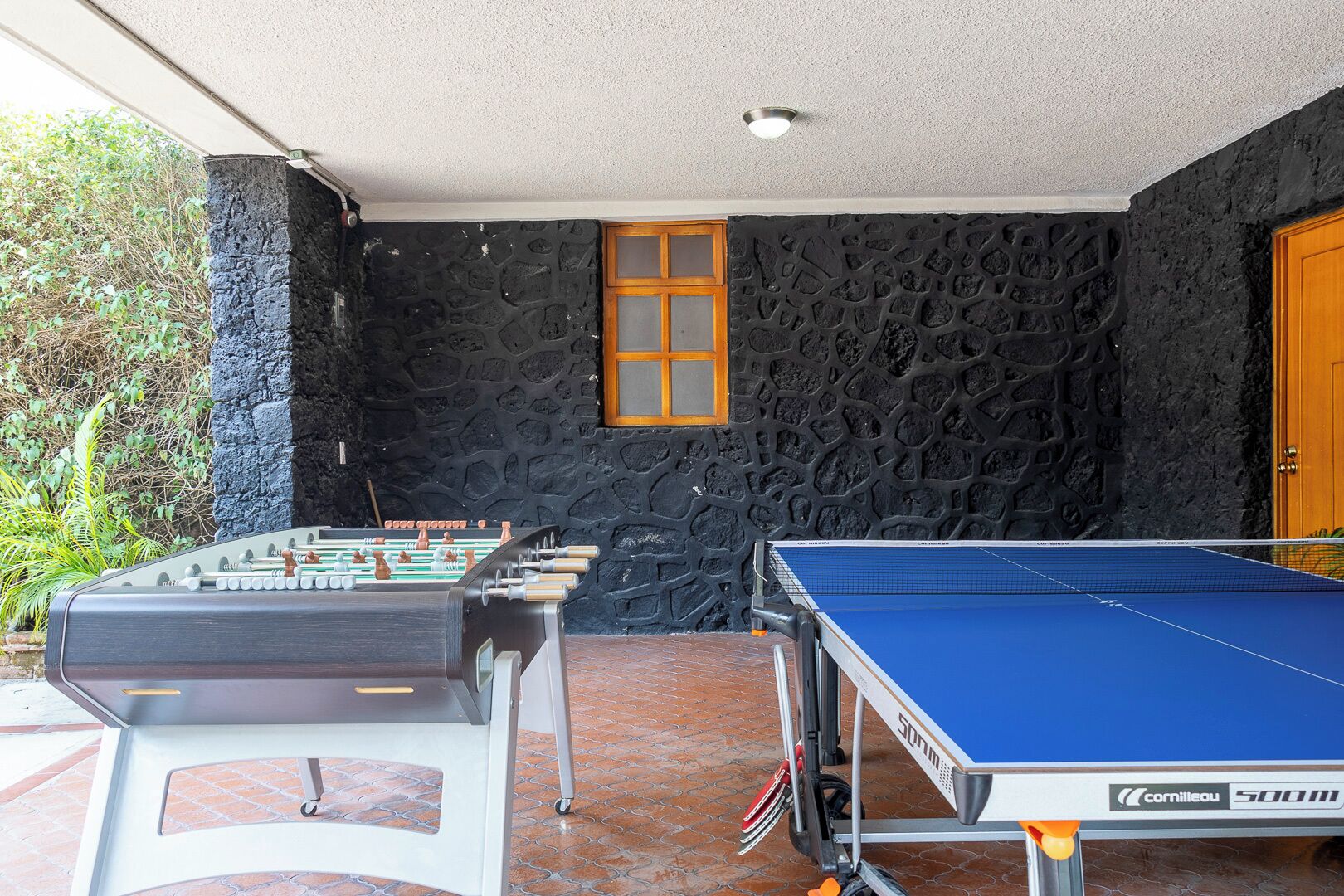 Une pièce équipée d’un baby-foot et d’une table de ping-pong.