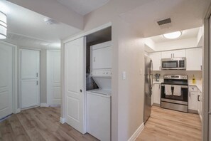 A modern kitchen with stainless steel appliances, a microwave, oven, and a refrigerator. - Walk to Old Town Gym, Pool, WD, Pkg  Balcony (Scottsdale)