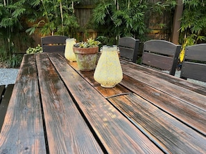 A wooden table with two potted plants and a decorative lamp. - Bright Airy Luxurious Abode in Walkable Riverside (Jacksonville)