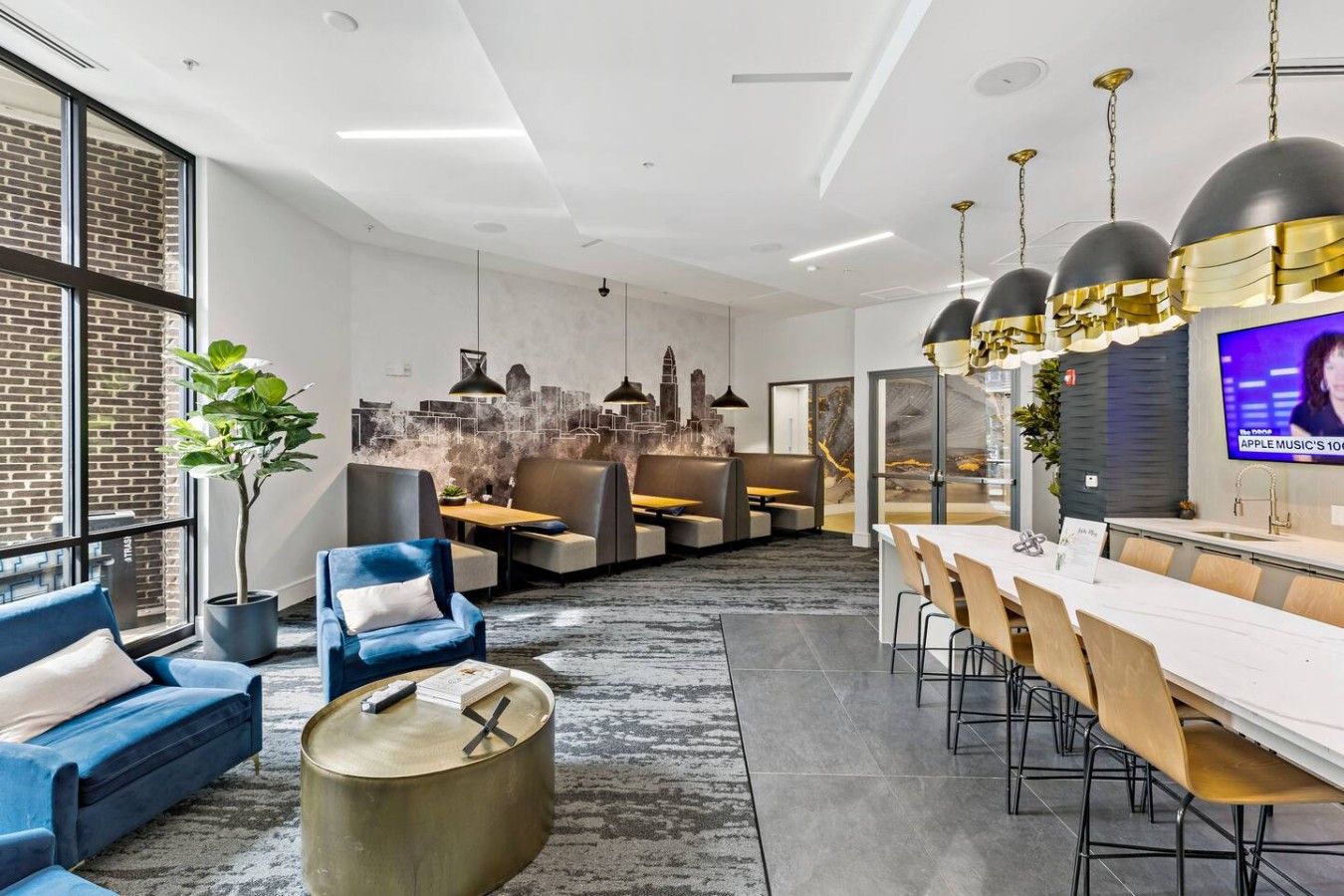 A modern interior with a dining area, seating, and a television screen.
