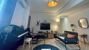 Family Apartment, City View | Living area | Flat-screen TV