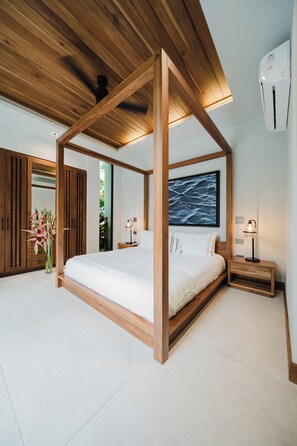 A modern bedroom with a wooden canopy bed, a large window, and a view of the outdoors.