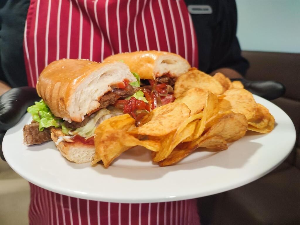 A plate with a sandwich and chips.