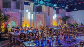 A banquet hall with multiple tables set for a formal event, featuring ornate wall decorations and a modern ceiling design. - Hesperia Maracay (Maracay)