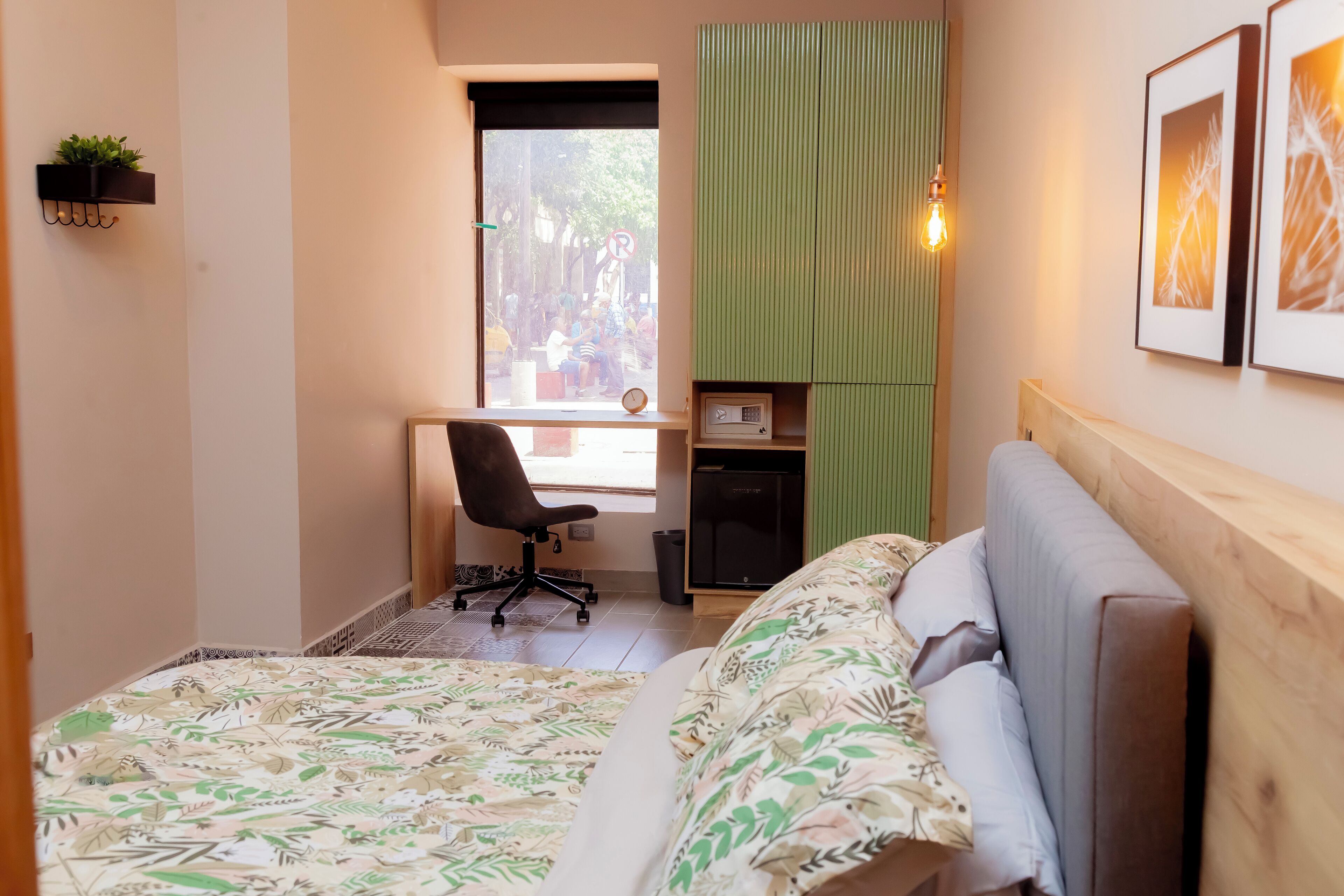 Une chambre à coucher de taille réduite, comprenant un lit, un bureau et une chaise.