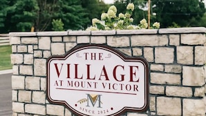 A sign for The Village at Mount Victor, indicating the name and establishment year. - Cozy, Clean Home for Family or Friends (Bowling Green)