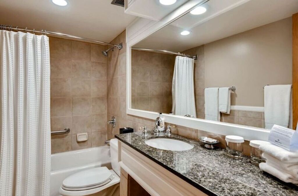 A modern bathroom with a bathtub, toilet, and sink.