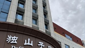 Un bâtiment doté d’une façade incurvée et d’une enseigne avec des caractères chinois.