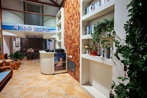 A hotel lobby with a reception desk, seating area, and a large window. - Beihai Yuhai Elegant Restaurant Hotel (Beihai International Passenger Transport Terminal) (Beihai)