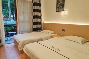 A hotel room with two beds, a small table, a chair, and a view of the outdoors. - Beihai Yuhai Elegant Restaurant Hotel (Beihai International Passenger Transport Terminal) (Beihai)