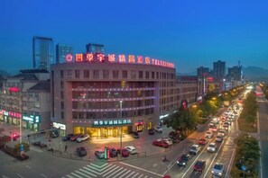 A multi-story hotel with a prominent signage, a central entrance, and a parking area. - Siji Yucheng Boutique Hotel (Anji Jiuzhou Shopping Mall) (Anji)