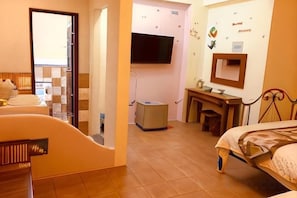 A hotel room with a bed, a desk, a television, and a bathroom. - Morpheus (Pingtung)