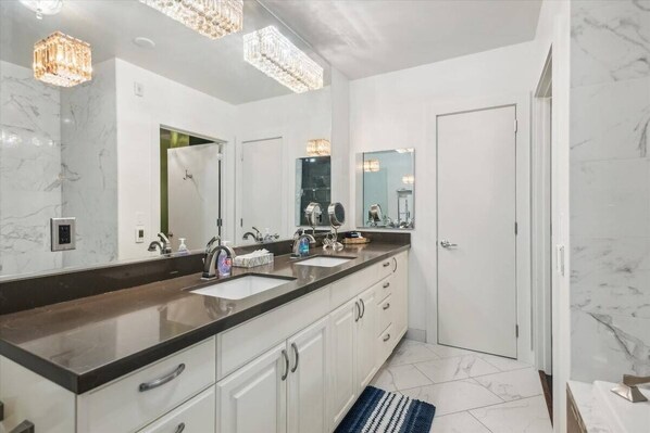 A modern bathroom with a large mirror, two sinks, and a walk-in shower. - Spacious 3BR/2BA w/ Steam Shower, Gated Parking & Full Kitchen (Portland)
