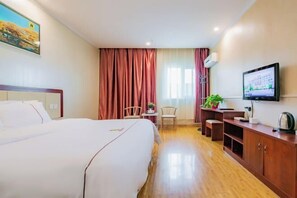 A hotel room with a large bed, a desk with a chair, a television, and a window with curtains. - Super 8 Hotel (Korla Tianshan West Road) (Korla)